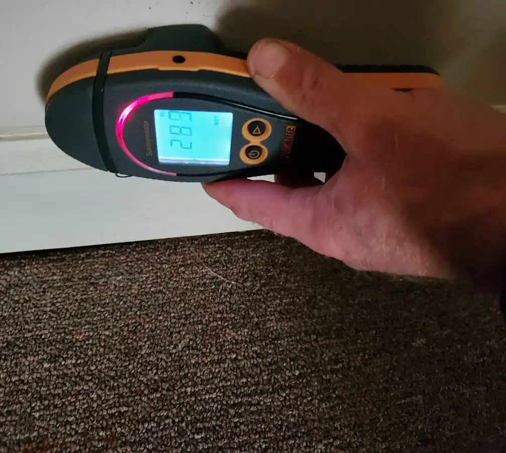 Moisture detection at baseboard during Storm Damage Restoration in Blanchard